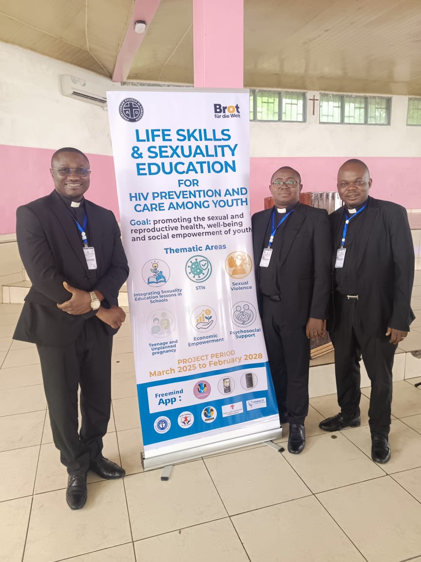Three clergy members beside the life skills and sexuality education programme banner